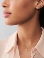 A single four-leaf clover necklace with guilloché floral carving technique in 18k rose gold.
